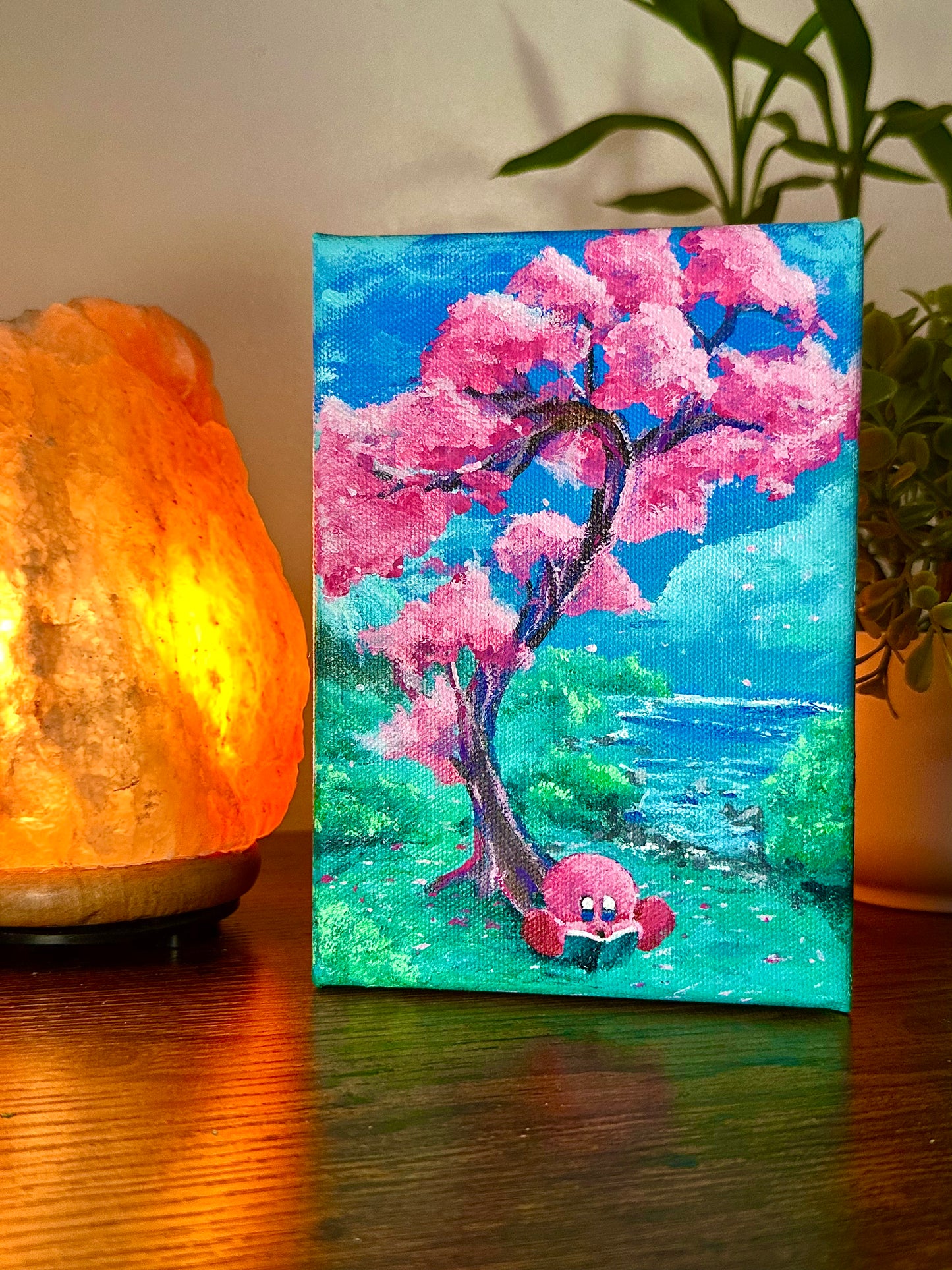 A Hungry Pink Blob Reading Under A Tree